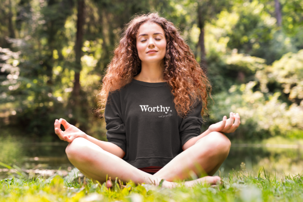 meditating woman in worthy crewneck